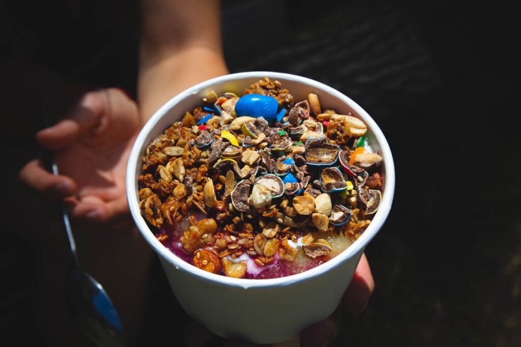 A bowl of creamy yogurt topped with fresh fruit, illustrating a simple probiotic snack