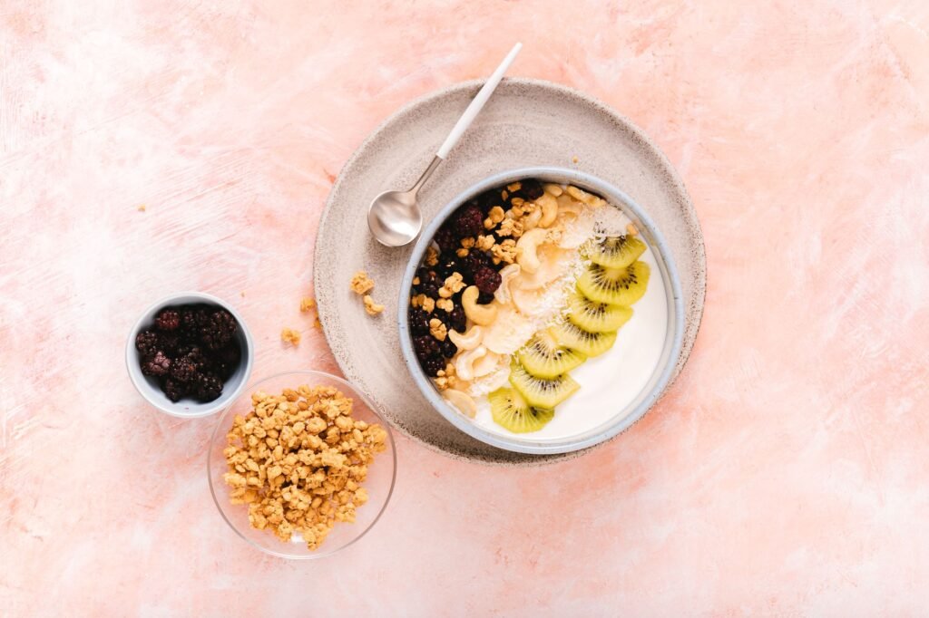 A bowl of creamy yogurt topped with fresh fruit, illustrating a classic probiotic snack