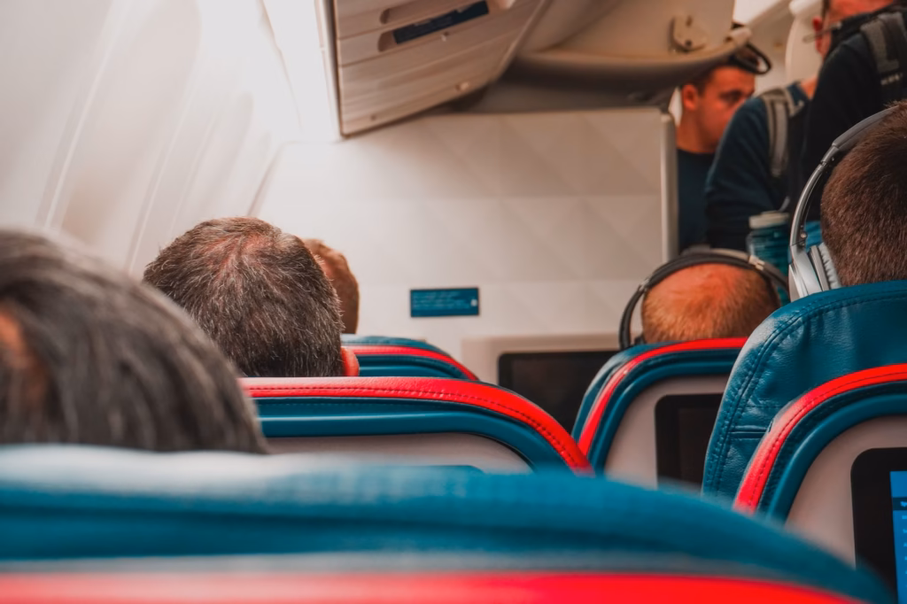 A calm airplane cabin where travelers can practice pressure‑equalizing techniques