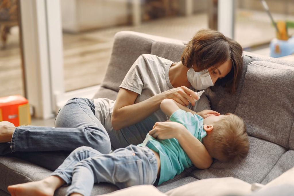 A caregiver gently administering liquid medication to a young child