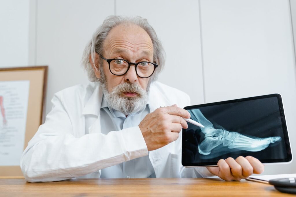 A clinician checking a patient’s hip alignment and movement