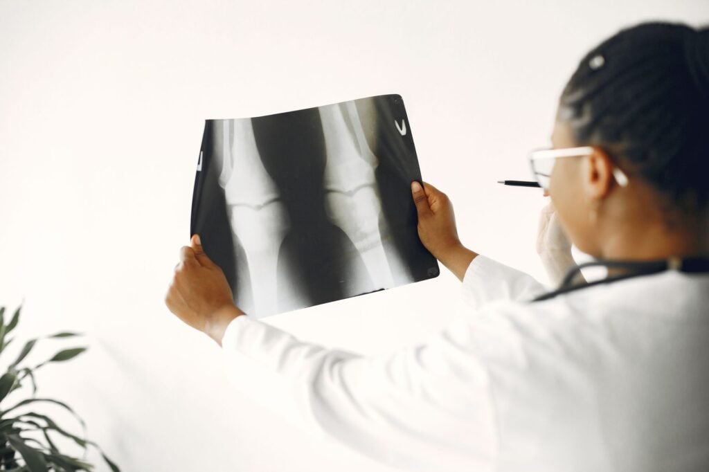 A clinician checking a patient’s knee, representing professional assessment of joint stiffness