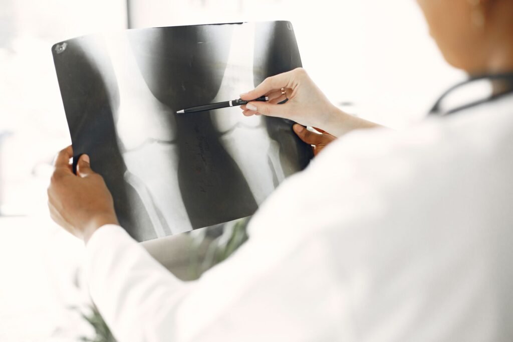 A clinician checks a patient's knee for swelling and tenderness