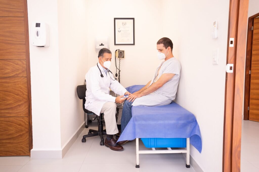 A clinician gently examines a patient’s knee for swelling and alignment
