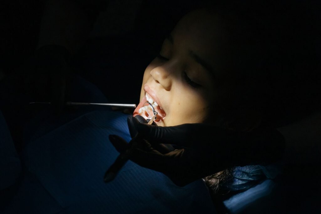 A dentist gently examining a patient’s upper molar area, highlighting careful assessment after extraction
