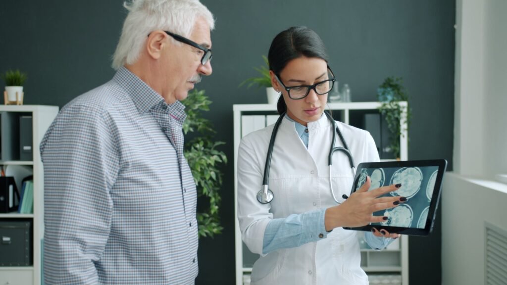 A doctor examines a spinal scan, illustrating the diagnostic process for chronic back pain