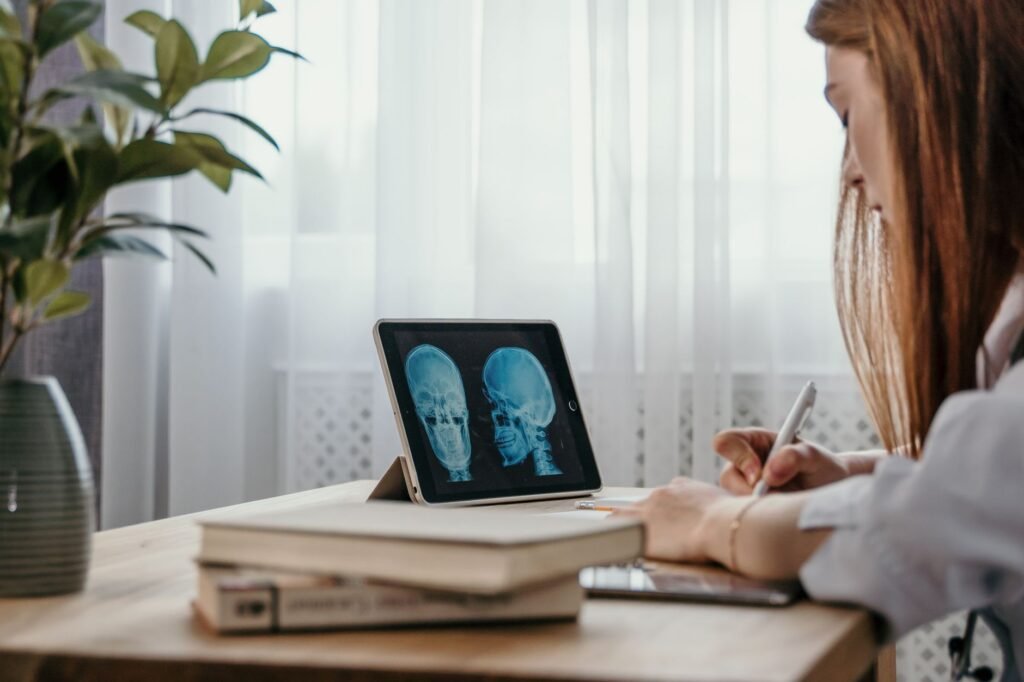 A doctor examines a spinal X‑ray to assess disc condition