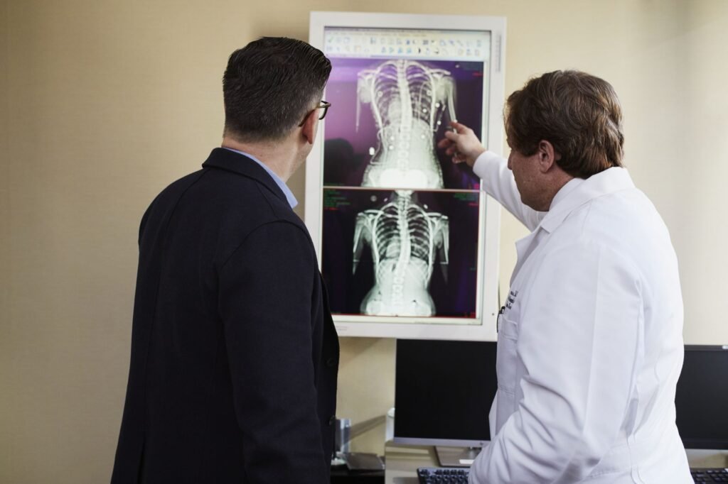 A doctor explains X-ray results to a patient in a clinical setting