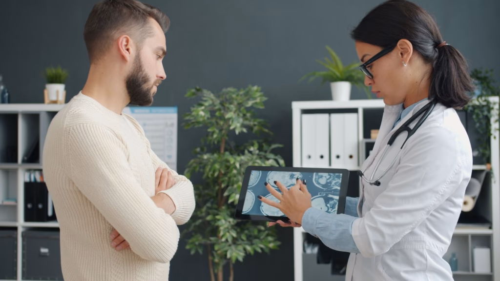 A doctor pointing at a diagram of the gut, illustrating how probiotics interact with intestinal bacteria