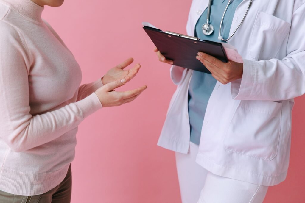 A doctor reviewing a patient’s joint symptoms in a calm clinic setting