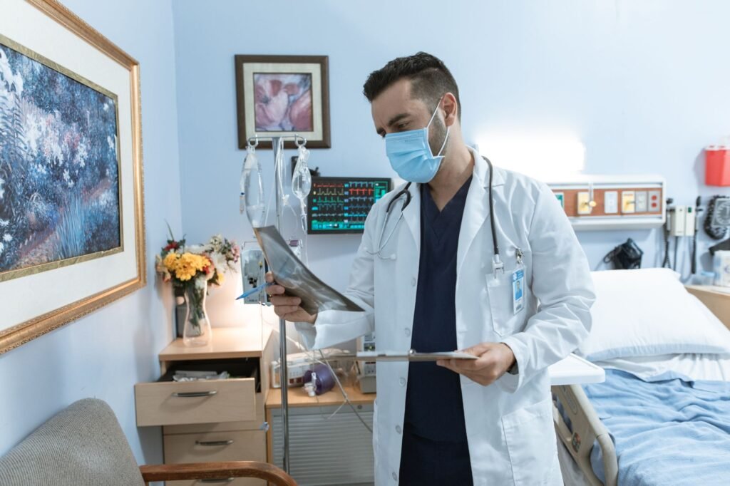 A doctor reviewing an X‑ray to confirm a fracture and plan treatment