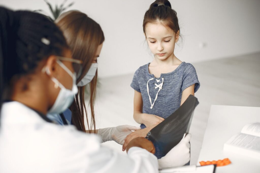 A doctor reviews a bone density scan on a computer screen, explaining the results to a patient