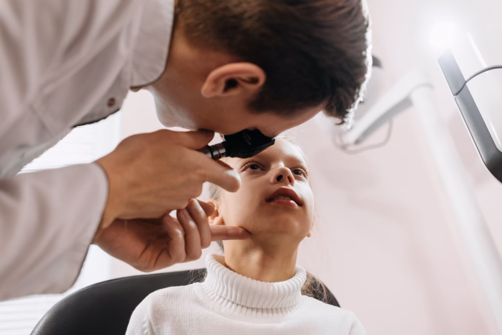A neuro‑ophthalmologist checking for papilledema during a routine eye exam