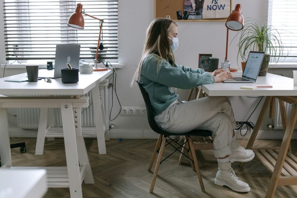 A person adjusts an ergonomic chair to support proper neck alignment while working