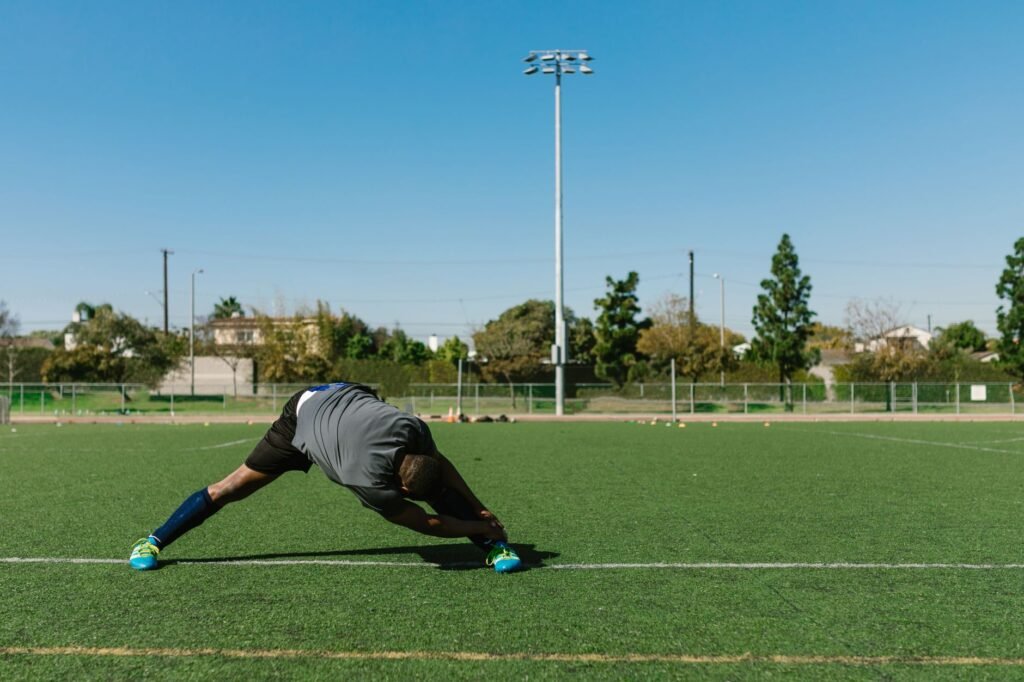 A person gently stretching a leg muscle before exercise
