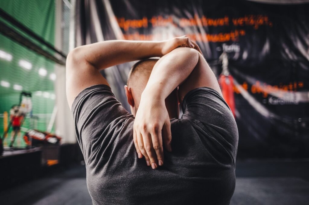 A person gently stretching to relieve back tension