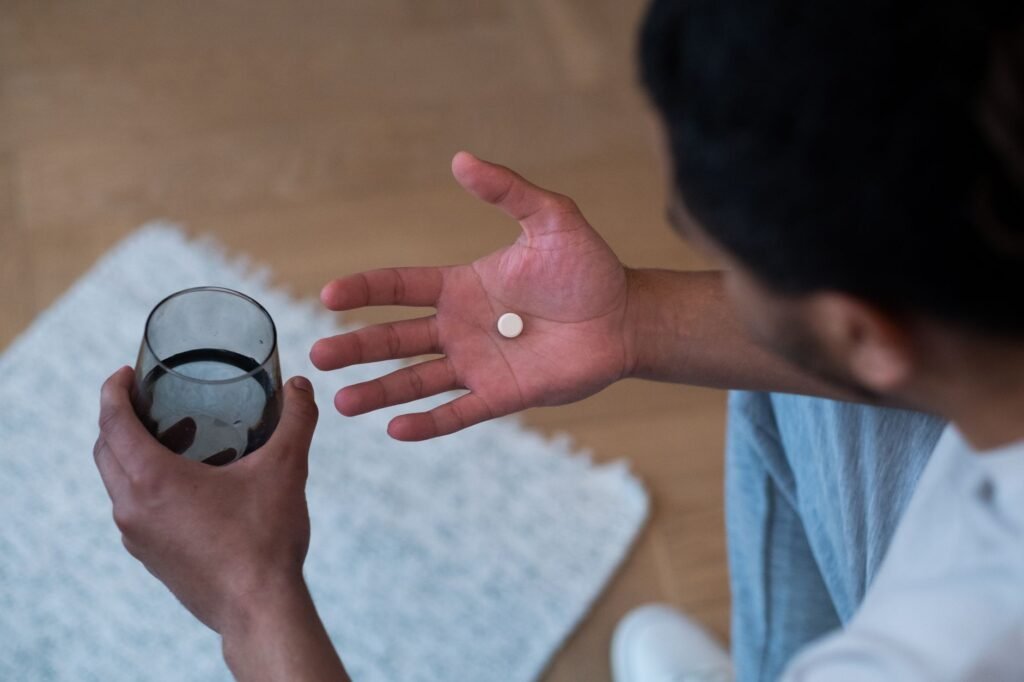 A person holding a probiotic supplement bottle illustrates supplement use