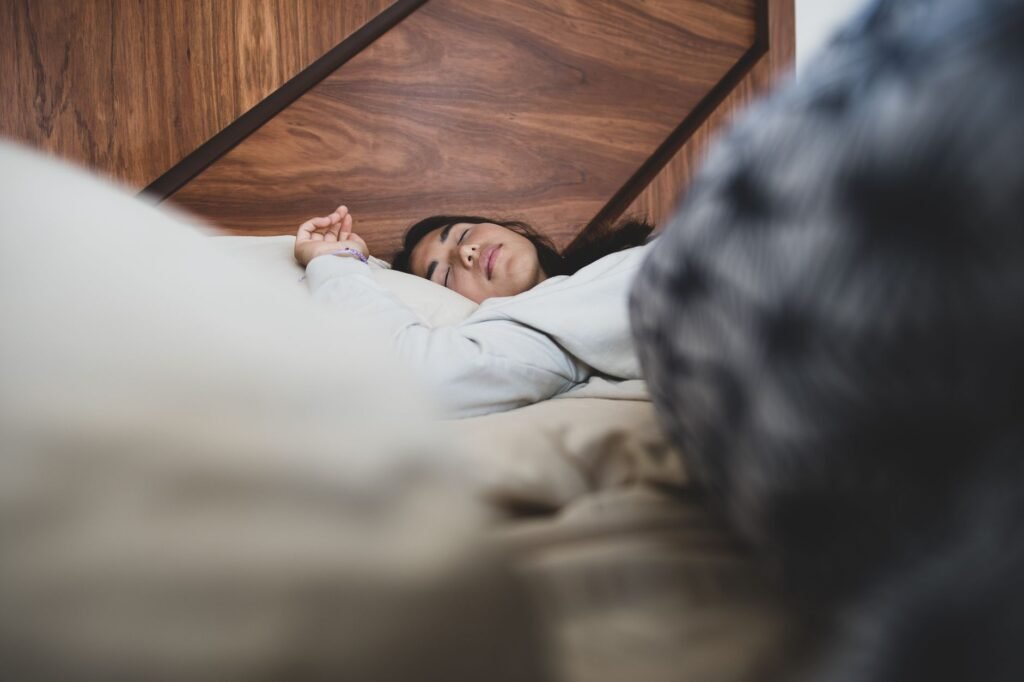 A person sleeps comfortably on a supportive mattress, highlighting the role of good sleep in back pain management