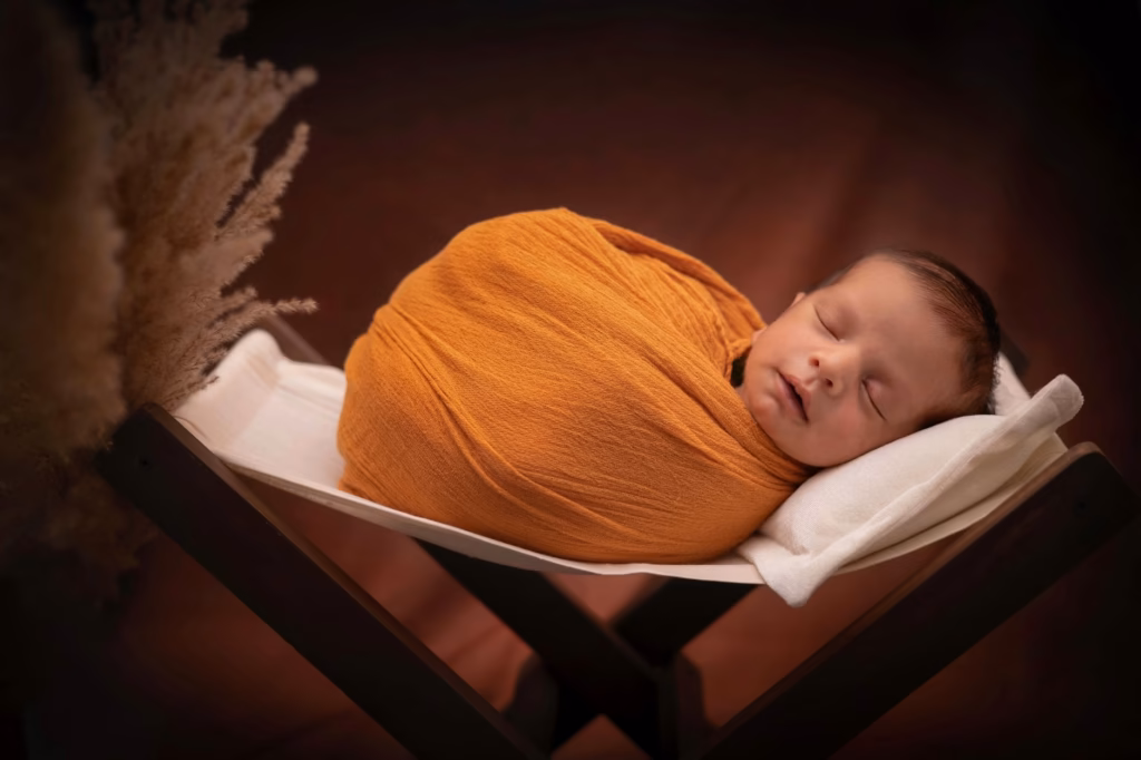 A sleepy baby swaddled, showing gentle soothing strategies for disrupted night sleep
