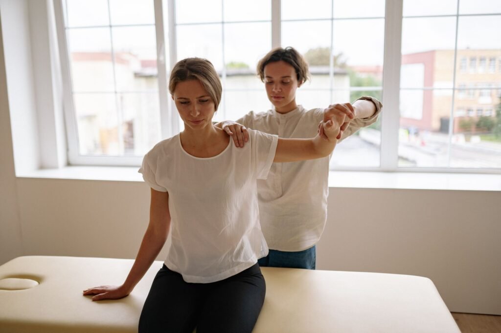 A therapist demonstrates a safe lifting technique to protect the lower back