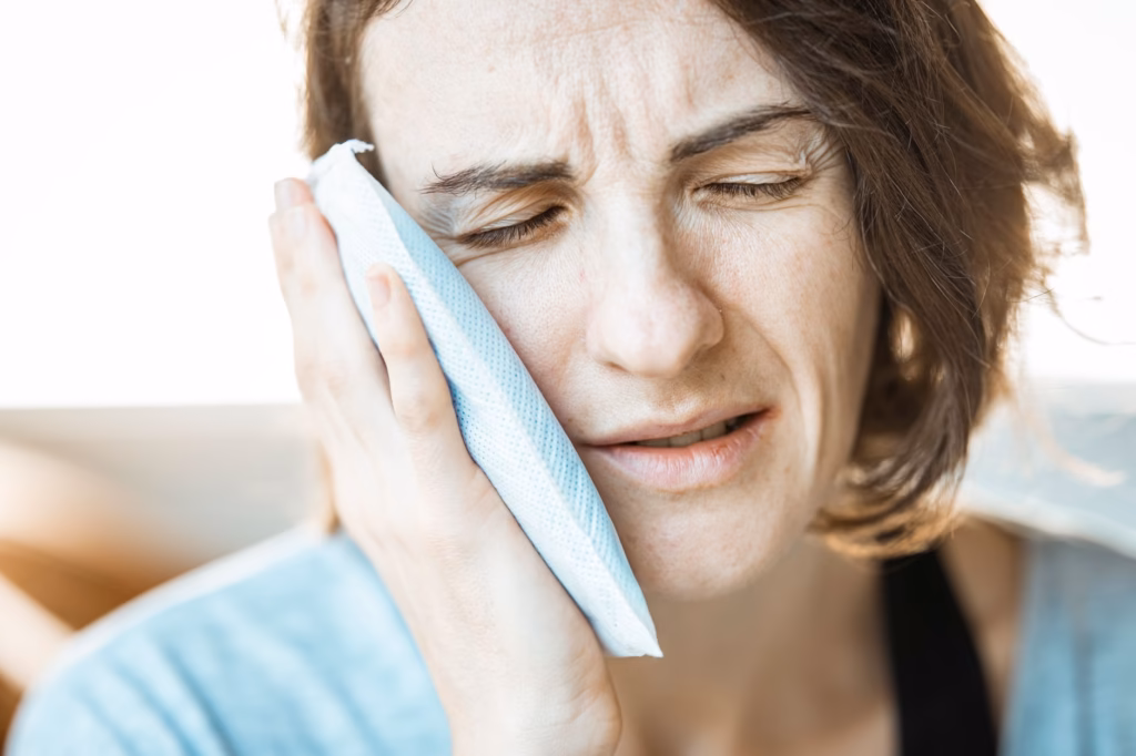 A warm compress applied to the cheek can soothe sinus pressure during a flight