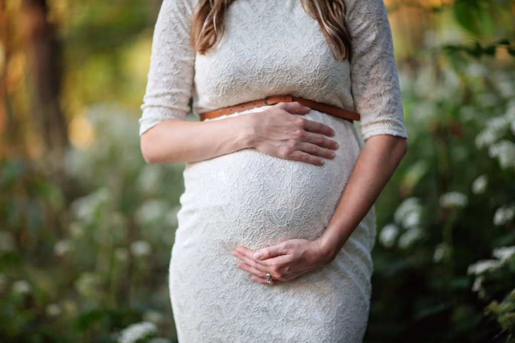 A woman gently holding her abdomen, illustrating bloating discomfort