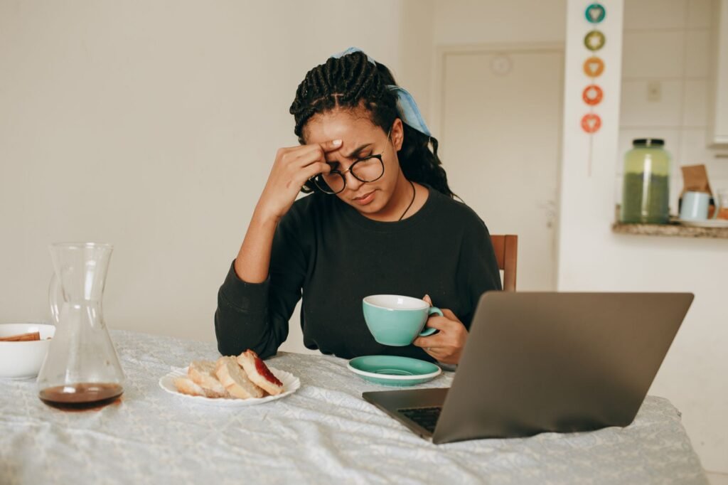 A woman gently holding her forehead, illustrating the head pressure many with fibromyalgia feel