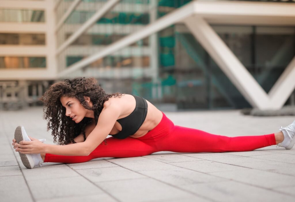 A woman gently stretching to ease back discomfort