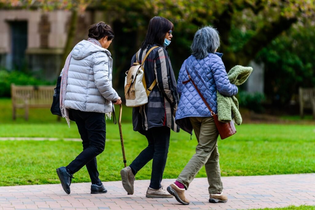 An older adult walks confidently on a paved path, illustrating the benefits of joint‑friendly exercise