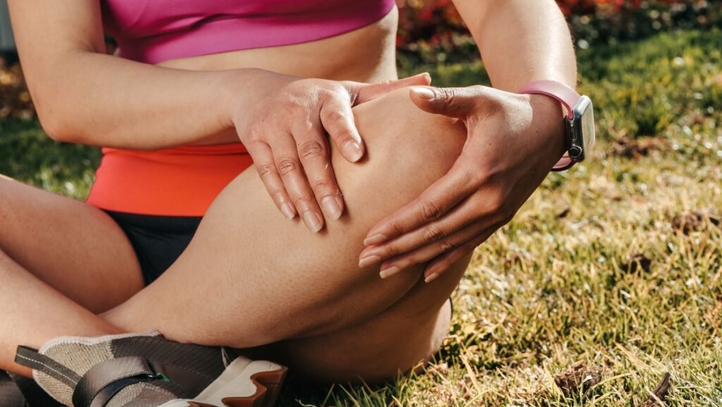 A doctor examining a swollen knee joint