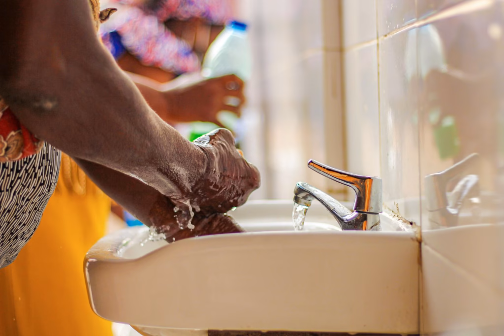 Close-up of hands being washed, highlighting hygiene to prevent illness