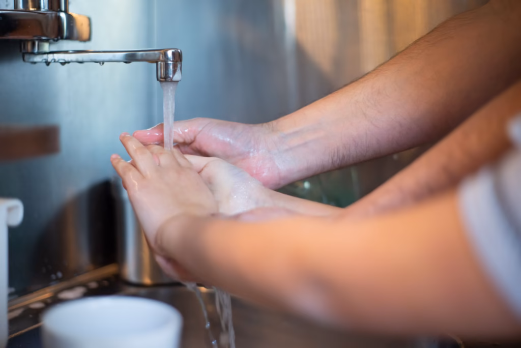 Family practicing hand hygiene to reduce spread of streptococcal infections