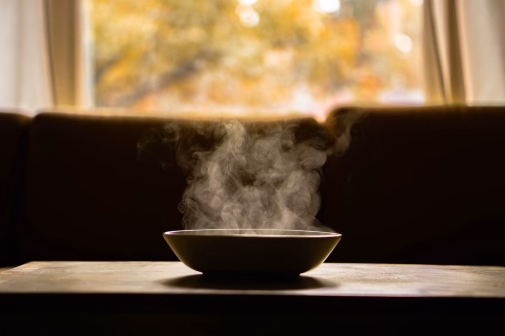 Person inhaling steam over a bowl, a common home remedy for sinus relief