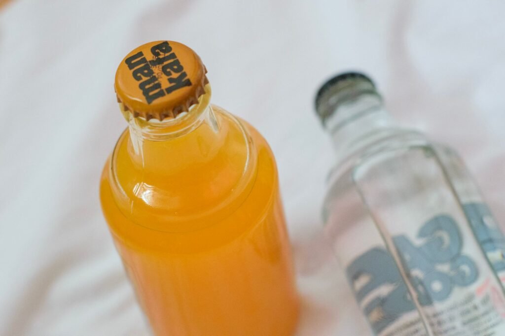 Top view of orange juice and soda bottles on a white background